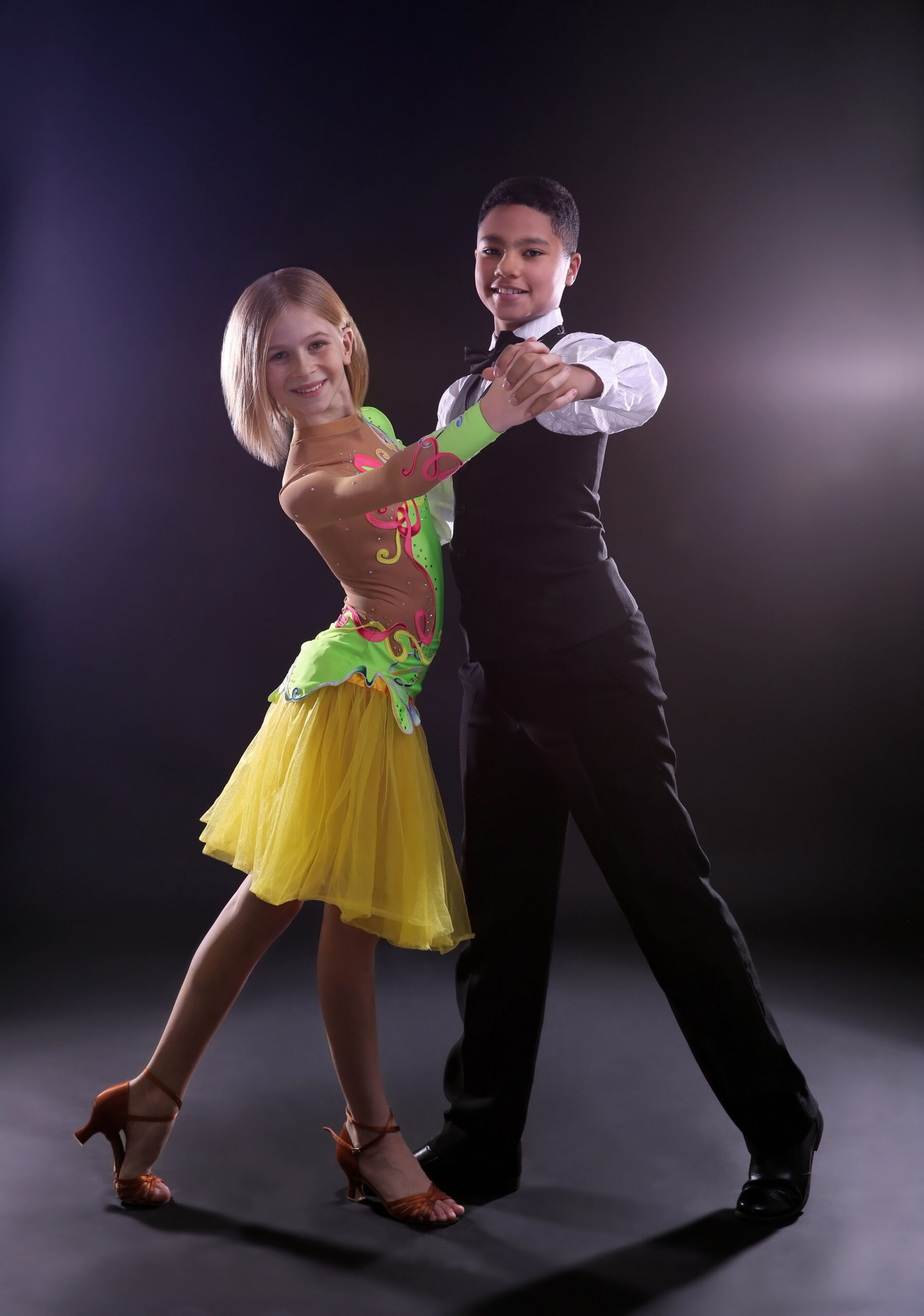 Two young ballroom dancers performing together